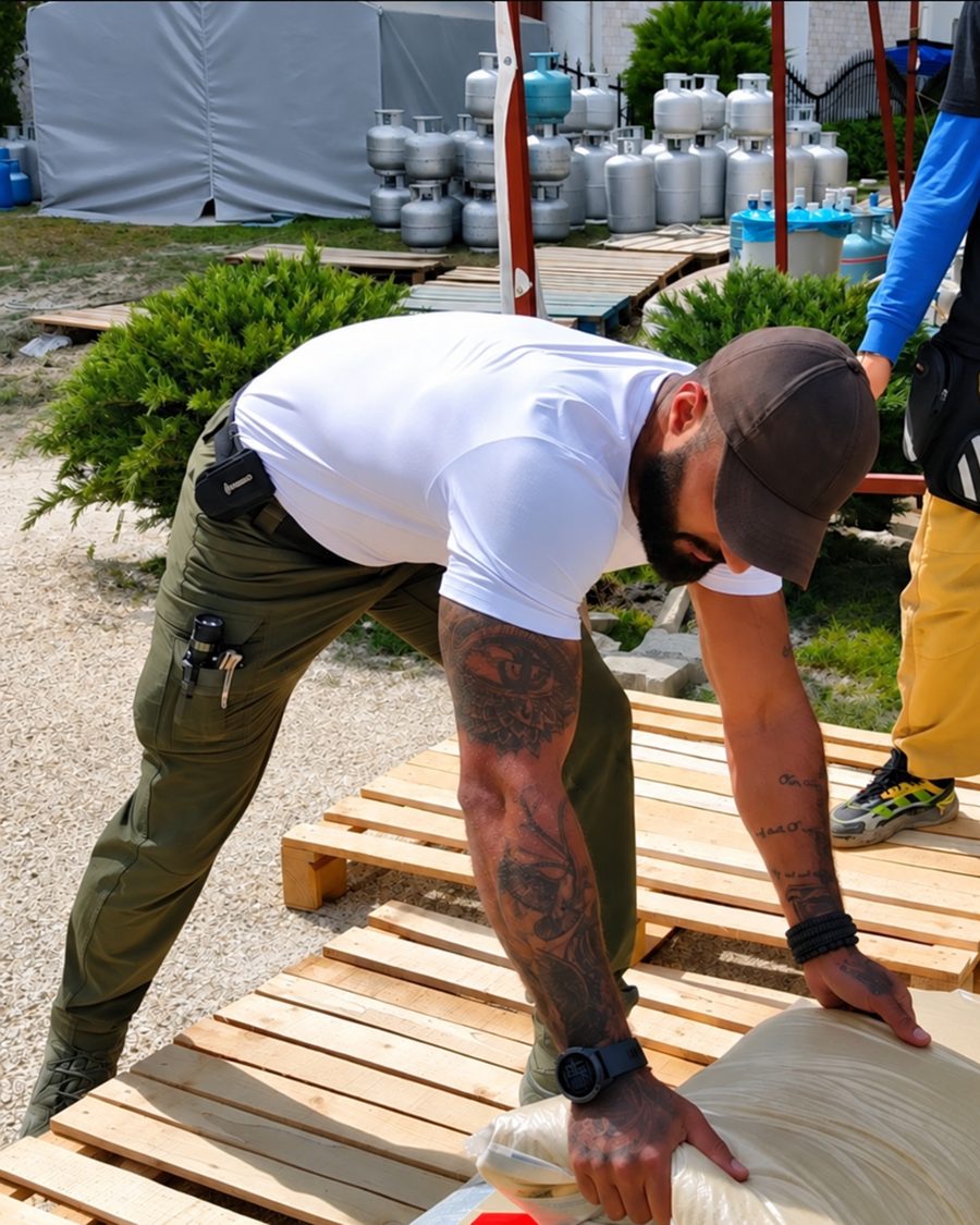 Benjamin Grant moving sacks of supplies onto pallets in Turkey
